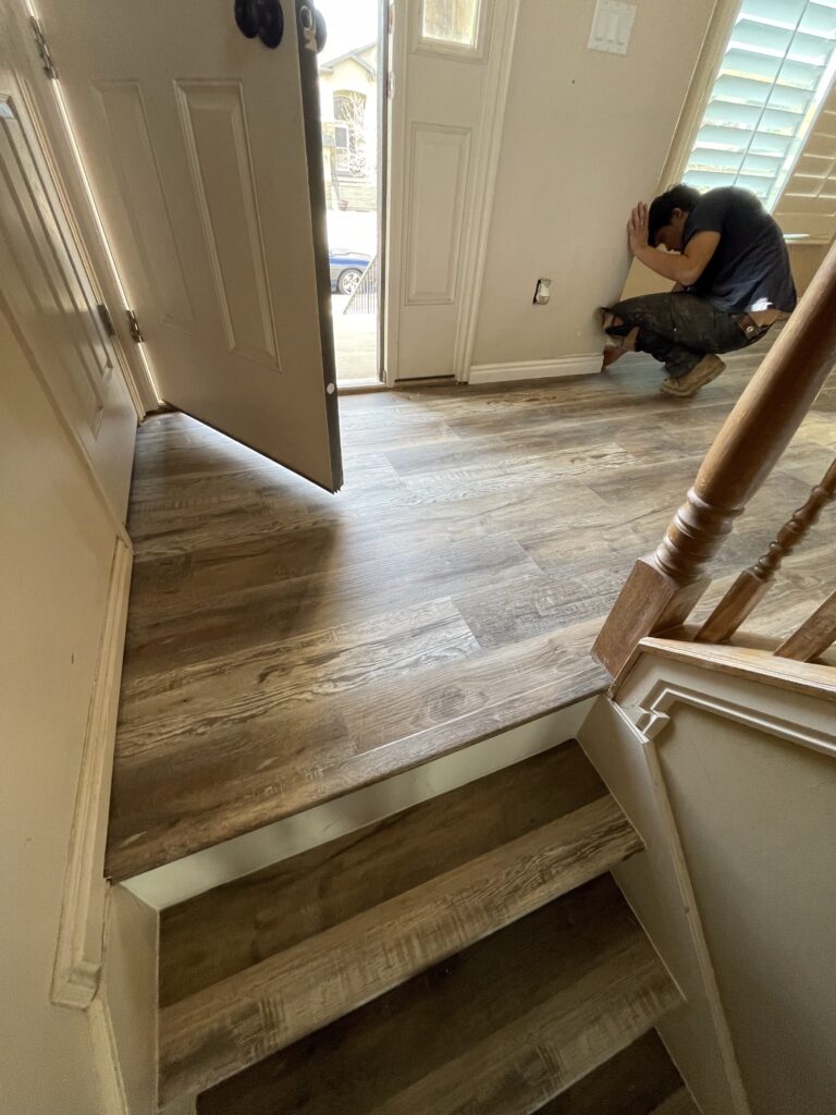 Professional floor installation company in Utah installing luxury vinyl plank flooring